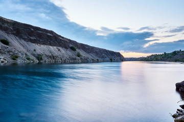 Fototapeta premium The purest blue lake amid unspoiled nature at dawn on a nice summer day