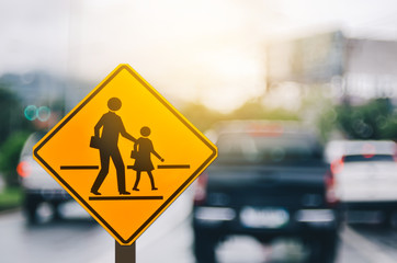 School zone warning sign on blur traffic road with colorful bokeh light abstract background. - Powered by Adobe