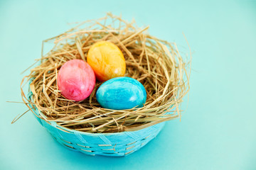 Bunte Eier zu Ostern im Nest und Korb