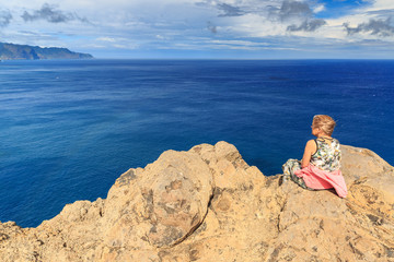 Fototapeta na wymiar Tourist on the cliffs in the beautiful landscape of the east coast of the island Madeira at Ponta de Sao Lourenco nature reserve