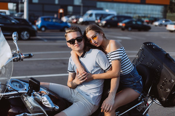 Hipster freedom stylish young modern couple in love on motorbike hugging  each other. Love, relathionships, speed, transport concept