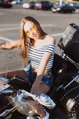 Fototapeta na wymiar Sport beuatiful sexy caucasian young hipster gorgeous girl on motorbike. Sport, fashion, gorgeous model concept