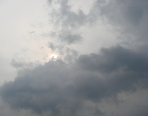 Panorama of the sky, where the southern sun tries to break through the dense wall of stormy clouds.