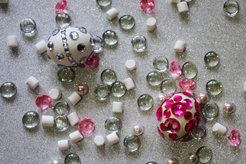 Easter composition flatlay. Easter eggs decorated with shiny rhinestones on  silver background with glass ornaments and pearl beads.
