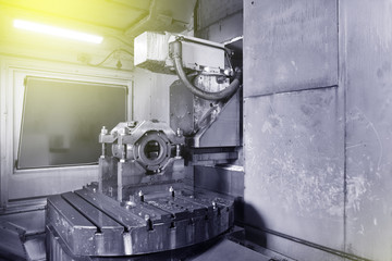 The body for creating the valve is installed on the table of the CNC machine for creating and grinding holes