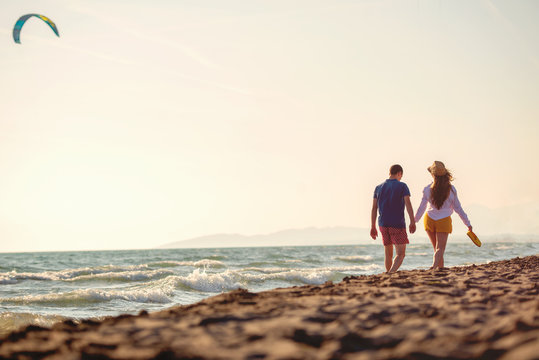 Happy Romantic Middle Aged Couple Enjoying Beautiful Sunset Walk on the Beach. Travel Vacation Retirement Lifestyle Concept