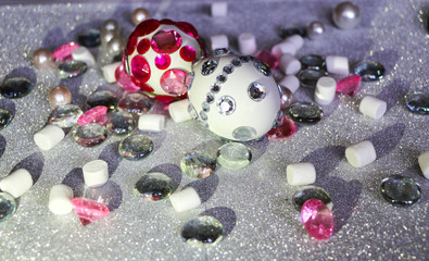 Easter composition flatlay. Easter eggs decorated with shiny rhinestones on  silver background with glass ornaments and pearl beads.