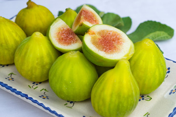 figs open over a plate full of figs.