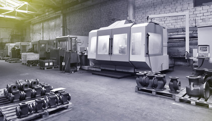 Fototapeta na wymiar CNC machines at the plant for the production of valves. Factory workspace