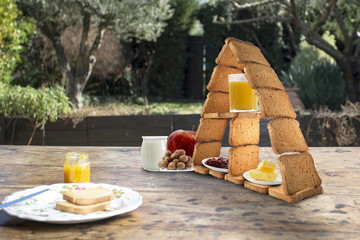 Balanced breakfast with a pyramid of rusks on an old wooden table