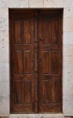 Ancient wooden door decoracted with carved frieze