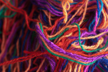 The intricated multi-colored yarn threads, close up, mess