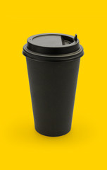 Large brown coffee paper cup on yellow background