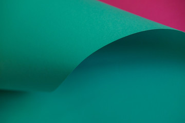 Abstraction of a design green and pink paper. Empty space on monochrome paper.