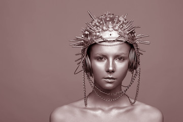 Futuristic woman in metal helmet with screws, nuts and chains