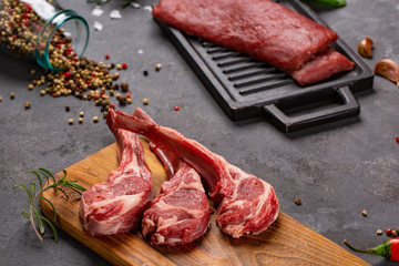 Pork with ribs. Tenderloin. Entrecote. Fresh and raw meat. Organic food. Meat with spices: pepper, salt