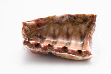 Smoked pork ribs vacuum packed on a white background