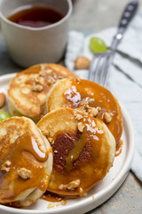 Macro pancakes with caramel on white plate