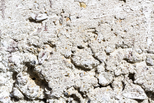 Texture of white  concrete wall. An old decrepid and uneven white wall lodge. Concrete texture. Cement  background.