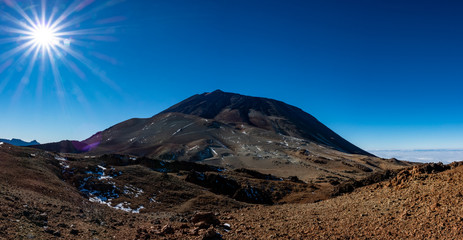 Teide mountain emerging in Tenerife against blue sky