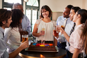 Business Team Meeting In Bar To Celebrate Female Colleagues Birthday