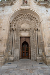 Entrance door of The Romanesque Parrocchia di San Giovanni Battista Parish church (chiesa). Saint John the Baptist in Matera, Basilicata, Italy. UNESCO World Heritage Site and capital culture