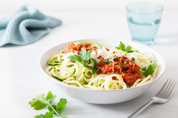 keto paleo zoodles bolognese: zucchini noodles with meat sauce and parmesan