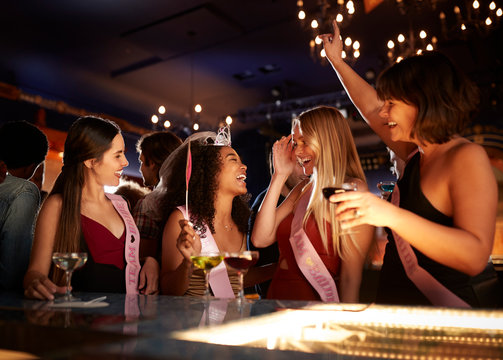 Group Of Female Friends Celebrating With Bride On Hen Party In Bar