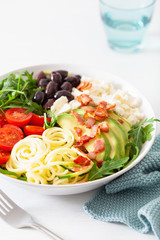 ketogenic lunch bowl: spiralized courgette with avocado, tomato, feta cheese, olives, bacon