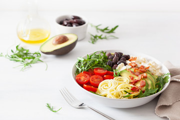ketogenic lunch bowl: spiralized courgette with avocado, tomato, feta cheese, olives, bacon