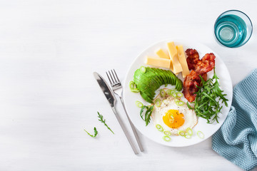 healthy keto breakfast: egg, avocado, cheese, bacon