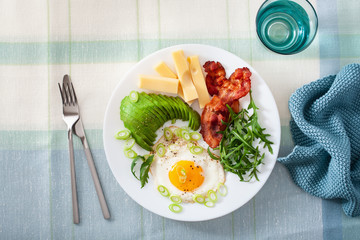 healthy keto breakfast: egg, avocado, cheese, bacon