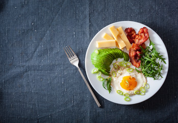 healthy keto breakfast: egg, avocado, cheese, bacon