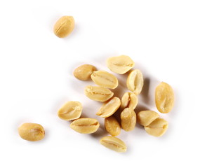 Salted and fried, roasted peanuts, pile isolated on white background, top view