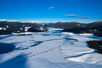 beautiful scenery with a mountain lake during winter seen from above