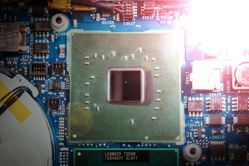 Computer Technology: Close up of a computer chip on a circuit board. Light effect.