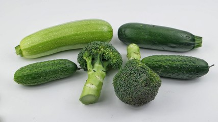 Vegetables and fruits of green color on the white background. Healthy food.