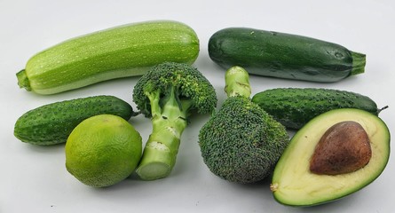 Vegetables and fruits of green color on the white background. Healthy food.