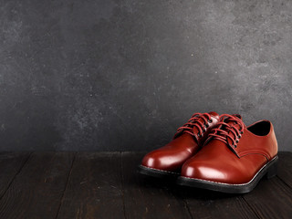 Stylish brown shoes for the groom, casual shoes on wooden background