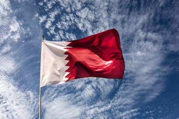 Naklejka na ściany i meble Flag of the country Qatar waving in the wind