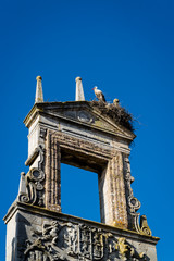 Fototapeta na wymiar Stork nesting on top of the ruins of an old monument, Burgos, Castile and Leon, Spain