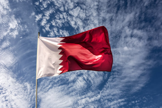Flag of the country Qatar waving in the wind