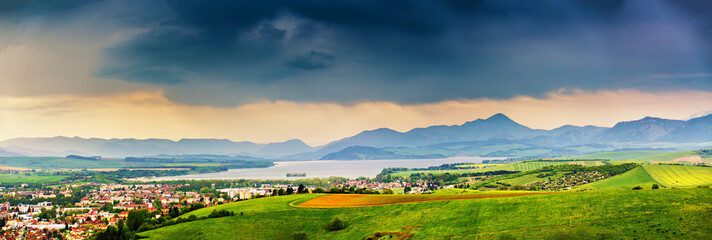 Spring storm in mountains panorama. Overcast dramatic sky