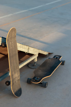 sakteboard and longboard at a skatepark