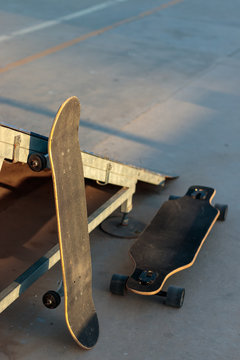 sakteboard and longboard at a skatepark