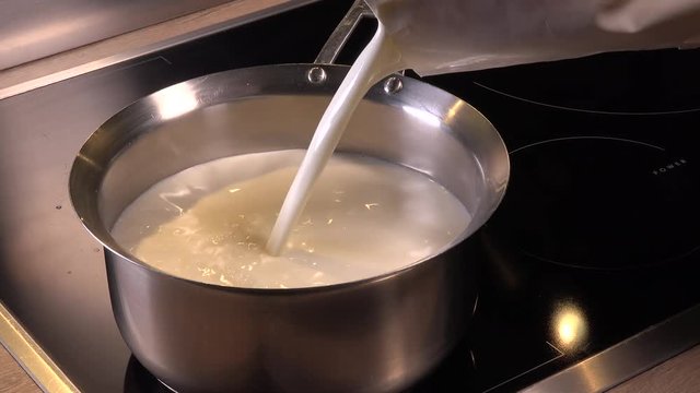 Cook natural organic milk, milk being poured into a pan