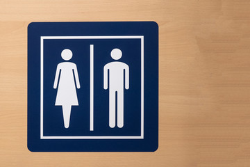 sign of male and female toilet on the wood background