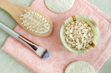 Rolled oats in a small bowl for preparing homemade facial mask and scrub. DIY oatmeal cosmetics.