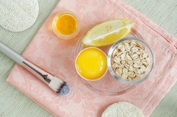 Oatmeal, raw egg, lemon and olive oil - ingredients for preparing diy face and hair masks, scrubs and moisturizers. Homemade beauty treatments recipe. Top view, copy space