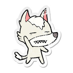 distressed sticker of a cartoon wolf waving showing teeth
